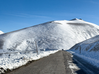 A winding road through snowy hills is seen in Campo Imperatore, Gran Sasso d'Italia, Italy, on November 16, 2024.  (