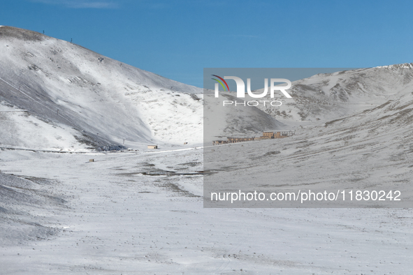   A snow-covered plateau with a mountain lodge nestled in the valley is seen in Campo Imperatore, Gran Sasso d'Italia, Italy, on November 16...