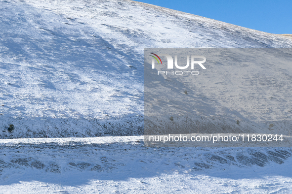 A winding road through snowy hills is seen in Campo Imperatore, Gran Sasso d'Italia, Italy, on November 16, 2024.  