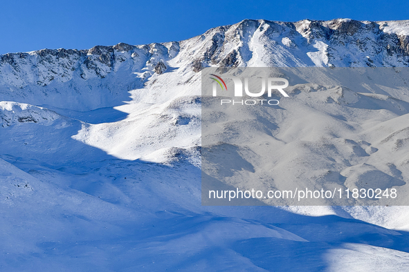 Shadows on the snow-covered slopes of the Gran Sasso massif in Campo Imperatore, Gran Sasso d'Italia, Italy, on November 16, 2024.  