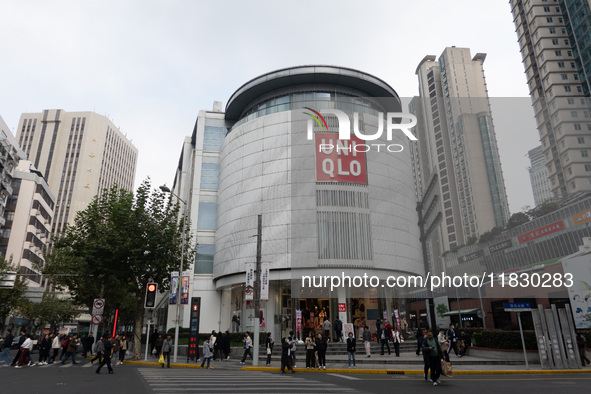 Customers pass by Uniqlo's global flagship store as it celebrates its 40th anniversary in Shanghai, China, on December 3, 2024. 