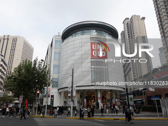 Customers pass by Uniqlo's global flagship store as it celebrates its 40th anniversary in Shanghai, China, on December 3, 2024. (