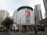 Customers pass by Uniqlo's global flagship store as it celebrates its 40th anniversary in Shanghai, China, on December 3, 2024. (