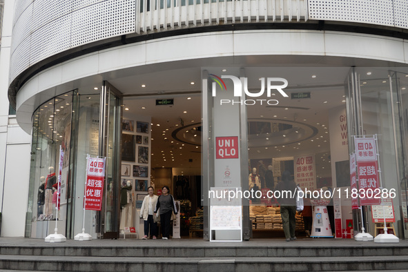 Customers pass by Uniqlo's global flagship store as it celebrates its 40th anniversary in Shanghai, China, on December 3, 2024. 