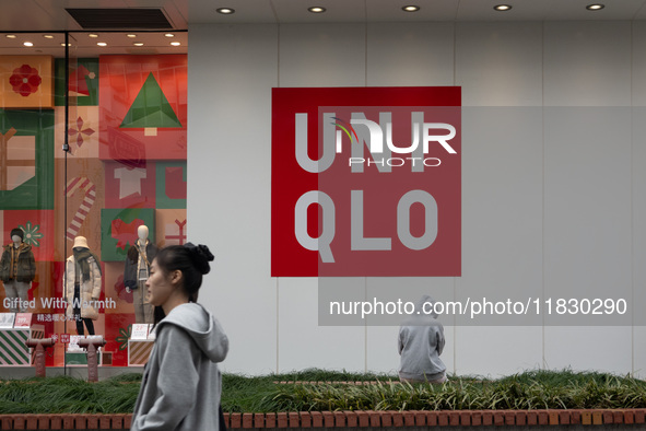 Customers pass by Uniqlo's global flagship store as it celebrates its 40th anniversary in Shanghai, China, on December 3, 2024. 