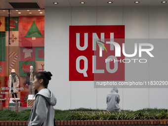 Customers pass by Uniqlo's global flagship store as it celebrates its 40th anniversary in Shanghai, China, on December 3, 2024. (