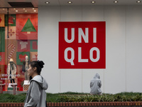 Customers pass by Uniqlo's global flagship store as it celebrates its 40th anniversary in Shanghai, China, on December 3, 2024. (