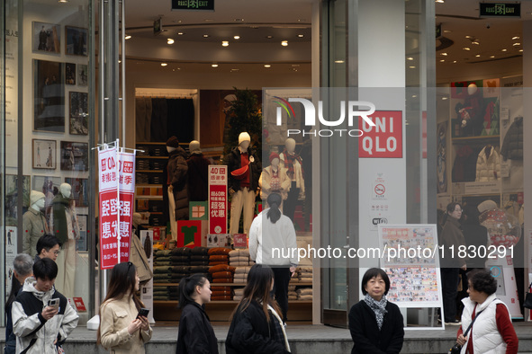 Customers pass by Uniqlo's global flagship store as it celebrates its 40th anniversary in Shanghai, China, on December 3, 2024. 