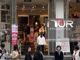 Customers pass by Uniqlo's global flagship store as it celebrates its 40th anniversary in Shanghai, China, on December 3, 2024. (