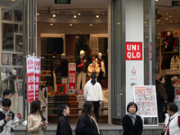 Customers pass by Uniqlo's global flagship store as it celebrates its 40th anniversary in Shanghai, China, on December 3, 2024. (