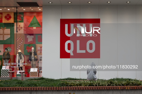 Customers pass by Uniqlo's global flagship store as it celebrates its 40th anniversary in Shanghai, China, on December 3, 2024. 