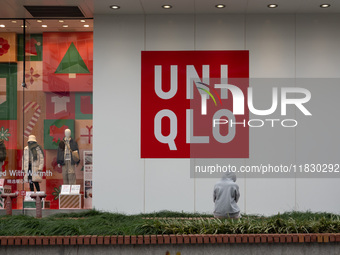 Customers pass by Uniqlo's global flagship store as it celebrates its 40th anniversary in Shanghai, China, on December 3, 2024. (