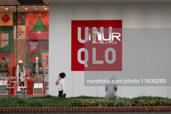 Customers pass by Uniqlo's global flagship store as it celebrates its 40th anniversary in Shanghai, China, on December 3, 2024. 