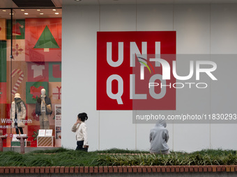 Customers pass by Uniqlo's global flagship store as it celebrates its 40th anniversary in Shanghai, China, on December 3, 2024. (