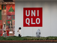 Customers pass by Uniqlo's global flagship store as it celebrates its 40th anniversary in Shanghai, China, on December 3, 2024. (