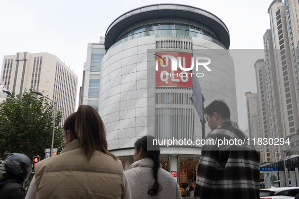 Customers pass by Uniqlo's global flagship store as it celebrates its 40th anniversary in Shanghai, China, on December 3, 2024. 