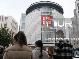 Customers pass by Uniqlo's global flagship store as it celebrates its 40th anniversary in Shanghai, China, on December 3, 2024. (