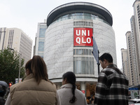 Customers pass by Uniqlo's global flagship store as it celebrates its 40th anniversary in Shanghai, China, on December 3, 2024. (