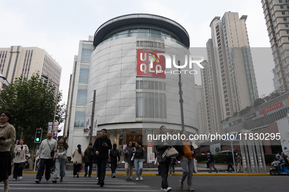 Customers pass by Uniqlo's global flagship store as it celebrates its 40th anniversary in Shanghai, China, on December 3, 2024. 