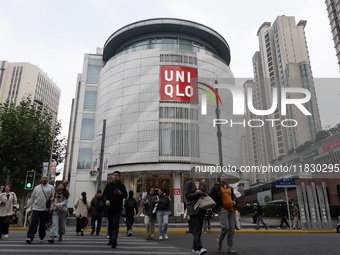 Customers pass by Uniqlo's global flagship store as it celebrates its 40th anniversary in Shanghai, China, on December 3, 2024. (