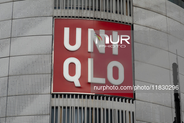 Customers pass by Uniqlo's global flagship store as it celebrates its 40th anniversary in Shanghai, China, on December 3, 2024. 