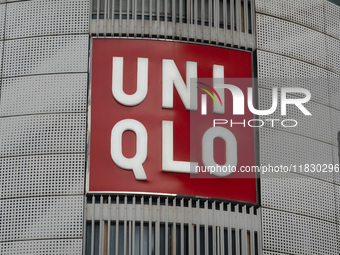 Customers pass by Uniqlo's global flagship store as it celebrates its 40th anniversary in Shanghai, China, on December 3, 2024. (