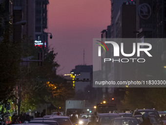 A view of a street in downtown Tehran, Iran, on December 2, 2024, at sunset. (