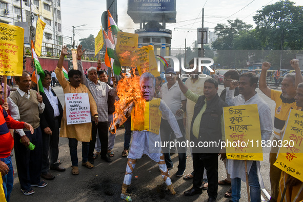 Protestors burn an effigy of Muhammad Yunus during a protest organized by South Kolkata District Congress in Kolkata, India, on December 3,...