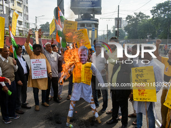 Protestors burn an effigy of Muhammad Yunus during a protest organized by South Kolkata District Congress in Kolkata, India, on December 3,...