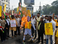 Protestors burn an effigy of Muhammad Yunus during a protest organized by South Kolkata District Congress in Kolkata, India, on December 3,...