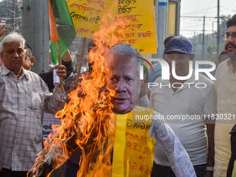 Protestors burn an effigy of Muhammad Yunus during a protest organized by South Kolkata District Congress in Kolkata, India, on December 3,...