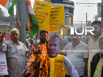 Protestors burn an effigy of Muhammad Yunus during a protest organized by South Kolkata District Congress in Kolkata, India, on December 3,...