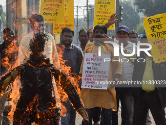 Protestors burn an effigy of Muhammad Yunus during a protest organized by South Kolkata District Congress in Kolkata, India, on December 3,...