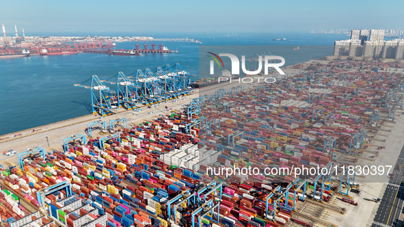 Several freighters load and unload cargo at the fully automated terminal of Qingdao Port in Qingdao, China, on December 3, 2024. 