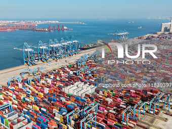 Several freighters load and unload cargo at the fully automated terminal of Qingdao Port in Qingdao, China, on December 3, 2024. (