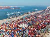 Several freighters load and unload cargo at the fully automated terminal of Qingdao Port in Qingdao, China, on December 3, 2024. (