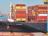 A cargo ship loads and unloads cargo at the fully automated terminal of Qingdao Port in Qingdao, China, on December 3, 2024. (