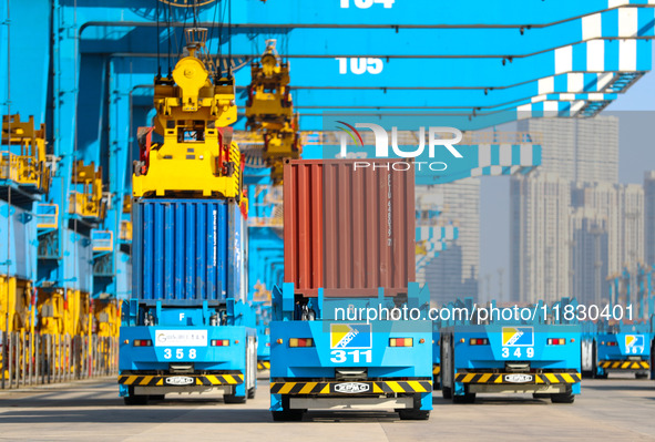 An automated guided vehicle delivers goods at a fully automated terminal in Qingdao Port in Qingdao, China, on December 3, 2024. 