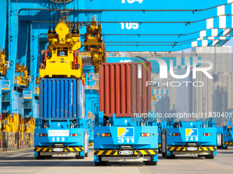 An automated guided vehicle delivers goods at a fully automated terminal in Qingdao Port in Qingdao, China, on December 3, 2024. (