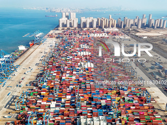 High-speed rail cranes work at a container yard at a fully automated terminal in Qingdao Port in Qingdao, China, on December 3, 2024. (