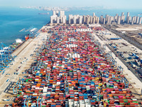 High-speed rail cranes work at a container yard at a fully automated terminal in Qingdao Port in Qingdao, China, on December 3, 2024. (