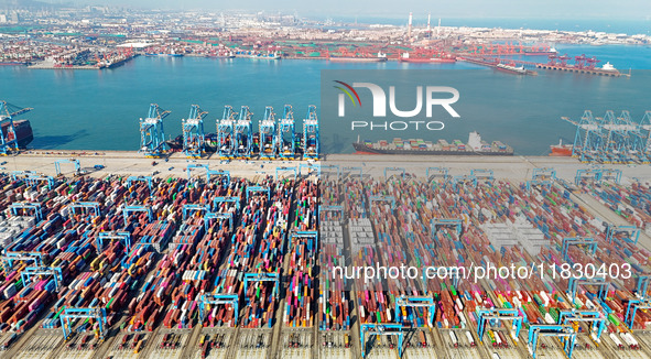 Several freighters load and unload cargo at the fully automated terminal of Qingdao Port in Qingdao, China, on December 3, 2024. 