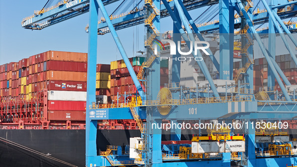 A cargo ship loads and unloads cargo at the fully automated terminal of Qingdao Port in Qingdao, China, on December 3, 2024. 