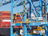 A cargo ship loads and unloads cargo at the fully automated terminal of Qingdao Port in Qingdao, China, on December 3, 2024. (