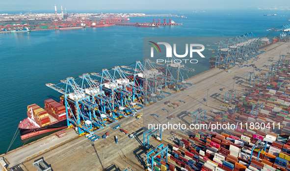 Several freighters load and unload cargo at the fully automated terminal of Qingdao Port in Qingdao, China, on December 3, 2024. 