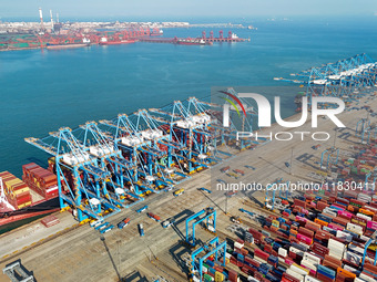 Several freighters load and unload cargo at the fully automated terminal of Qingdao Port in Qingdao, China, on December 3, 2024. (