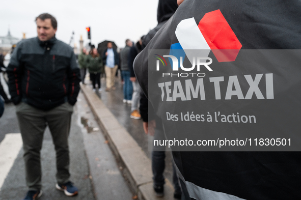 Taxi drivers gather at the Invalides in Paris, France, on December 3, 2024, during a demonstration against a new downward pricing system for...