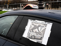 Taxi drivers gather at the Invalides in Paris, France, on December 3, 2024, during a demonstration against a new downward pricing system for...