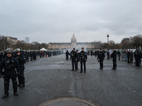 French Republicain Security Corps (CRS) officers face taxi drivers at the Invalides. Taxi drivers gather at the Invalides during a demonstra...