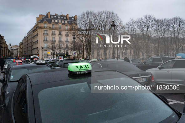 Taxi drivers gather at the Invalides in Paris, France, on December 3, 2024, during a demonstration against a new downward pricing system for...